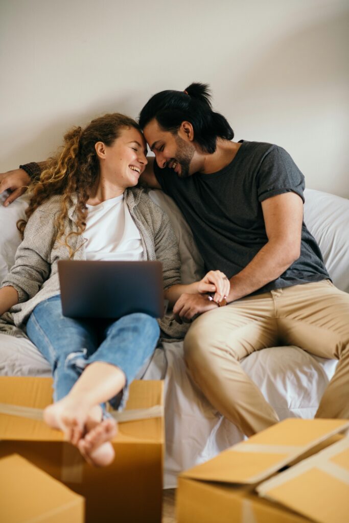 couple reviewing moving quotes online using AI moving app